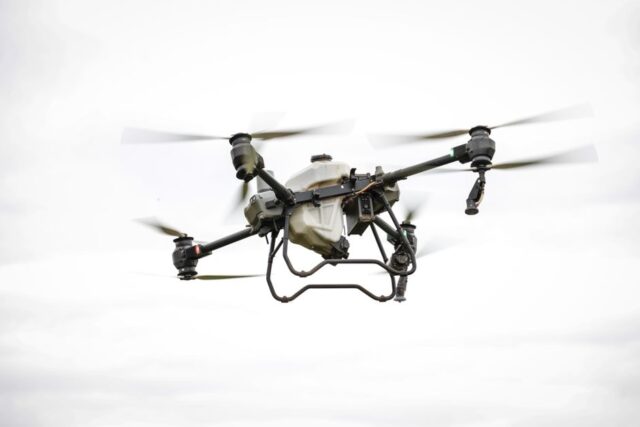 Aerial view of a drone surveying a construction site, showcasing its utility in mapping and inspection.
